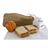 brown lunch bag with split sandwich, milk and an apple